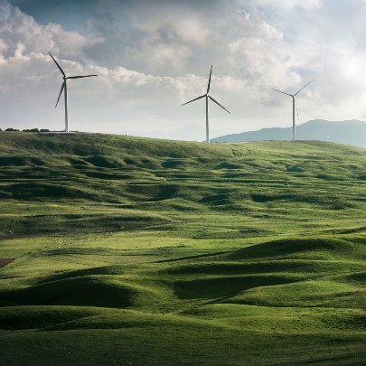 square image of wind turbines on a hill