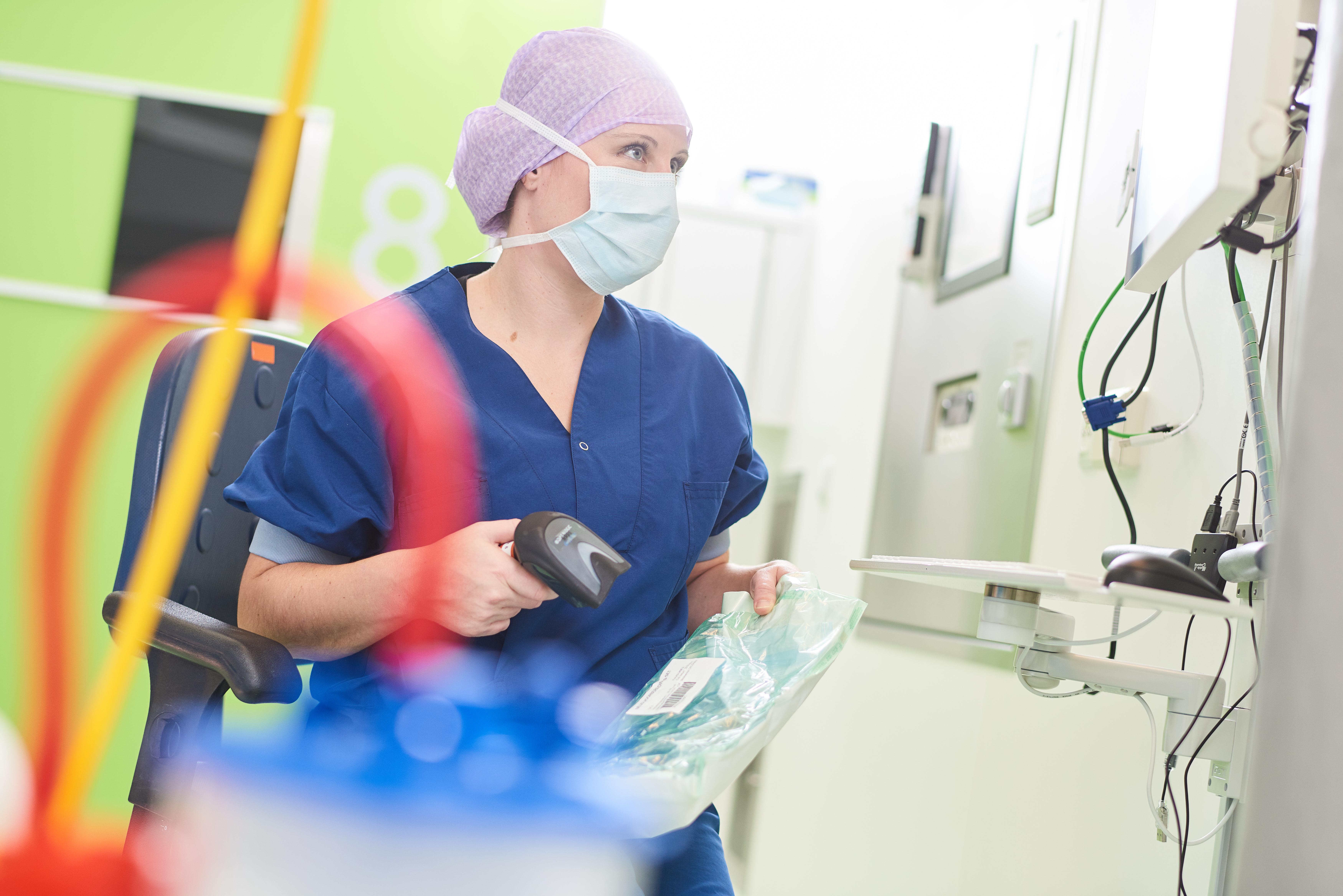 Theatre nurse scanning medical device