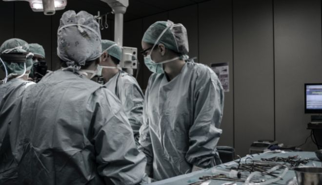 Health care professionals in scrubs in a theatre