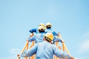 Construction workers on a ladder