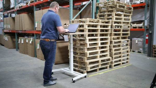 man in warehouse on computer