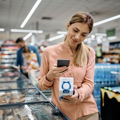 woman scanning QR code in shop