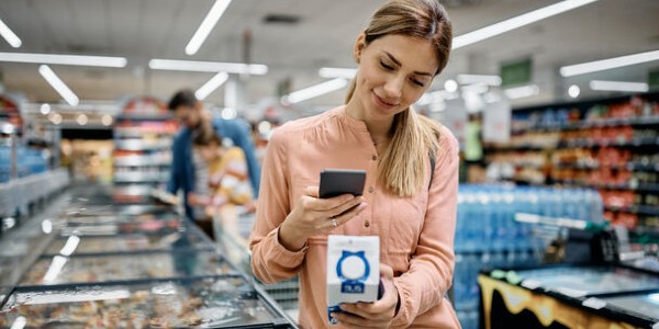 woman scanning QR code in shop