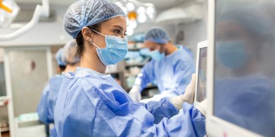 Theatre nurse using medical equipment