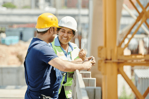 Two people on a construction site