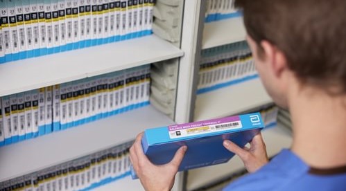 Clinician holding a medical device with a UDI label