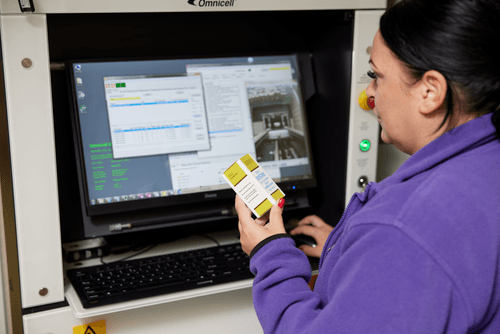 Pharmacist checking medicines on the screen of a pharmacy robot
