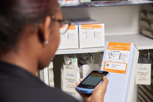 Person scanning a medical device with a GS1 2D DataMatrix barcode