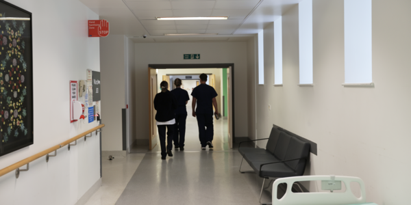Clinicians walking down a hospital corridor