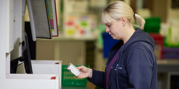pharmacist checking packaging