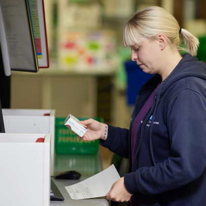 pharmacist checking packaging